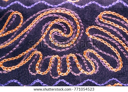 Abstract spiral embroidery. Closeup. Selective focus