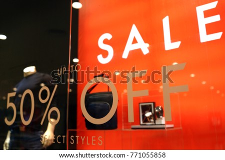 Special black Friday sale up to 50% off text on a glass wall obstruct a view inside the popular clothing store