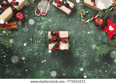 Boxes with gifts for Christmas and various attributes of holiday on a green background. Top view. Snow
