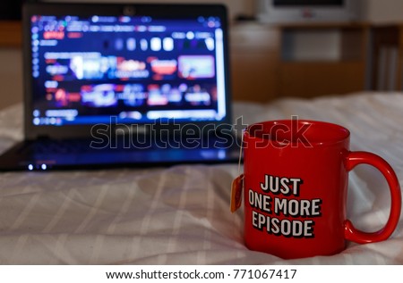 Watching series with a cup of tea. Just one more episode. Royalty-Free Stock Photo #771067417