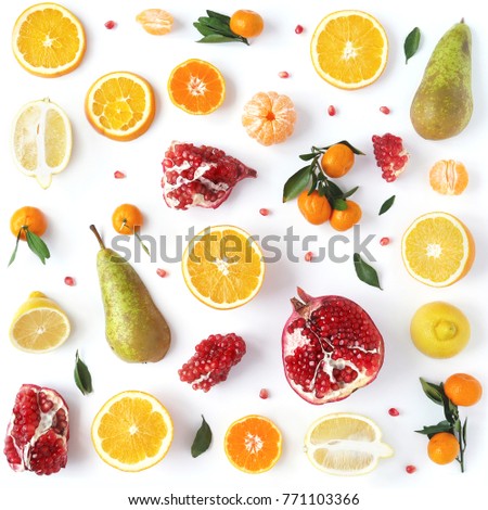 Composition from orange, pomegranate, mandarins with leaves isolated on white background. Food pattern of fruits. Creative flat layout of fruit slices, top view.