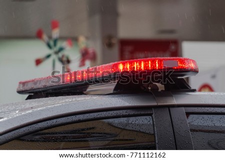 closeup of police cop officer law emergency service car siren, police headlight on raining road.