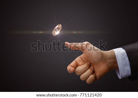 Hand throws a coin. The concept of decision-making. Royalty-Free Stock Photo #771121420