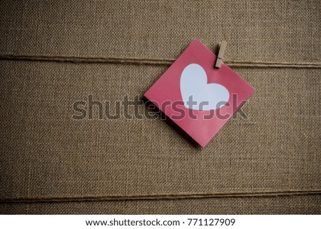 Hanged note paper with love sign - sackcloth background