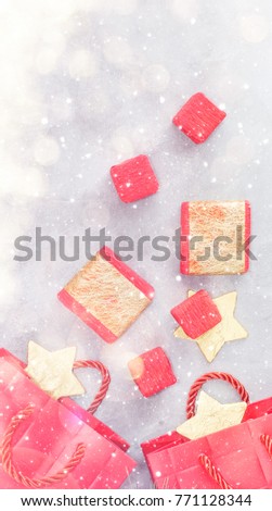 Christmas background: shopping bags, gift boxes and gold stars under snow. New year concept. Text space