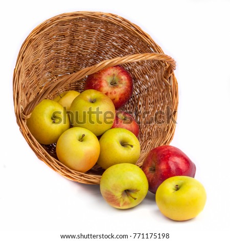 apples in a wicker basket on a white background
