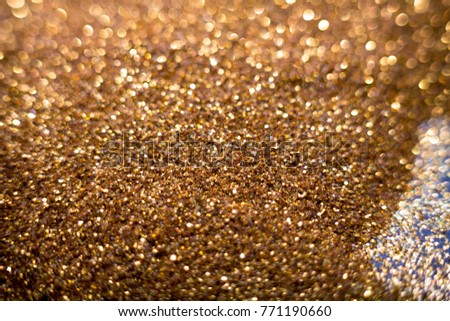 Golden and silver glitter backgound with bokeh abstract blur effect 