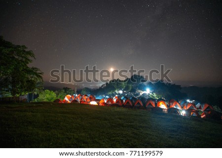 Glowing camping tent in the night mountain with Milky way and Star