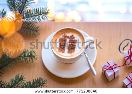 Christmas coffee in a white cup with a gift picture on white foam Royalty-Free Stock Photo #771208840
