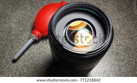 Cleaning lens of DSLR camera by air blower, Focus at lens