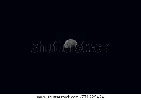 Half moon at night on black sky background.
