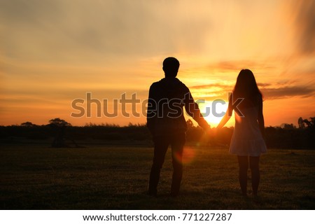 Shadow image of couples holding hands with the morning light.Hand in hand together,selective focus with Lens Flare,silhouette