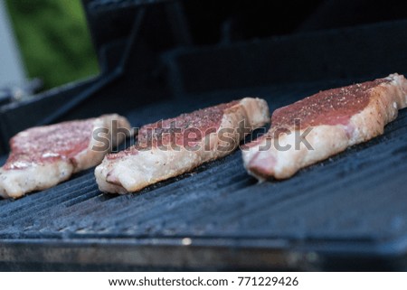 Steaks cooking on a gas grill