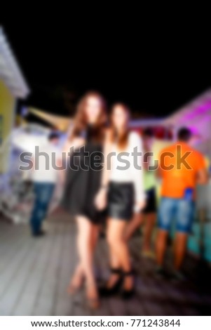 Blurred for background. night club party. People during concert in night club party. Blurred Crowd People. Abstract blurry festival event with beautiful lights decoration inside night club background