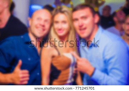 Blurred for background. night club party. People during concert in night club party. Blurred Crowd People. Abstract blurry festival event with beautiful lights decoration inside night club background.