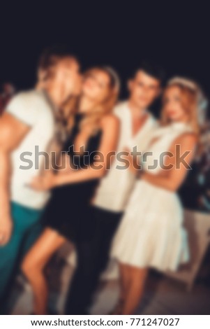 Blurred for background. night club party. People during concert in night club party. Blurred Crowd People. Abstract blurry festival event with beautiful lights decoration inside night club background.