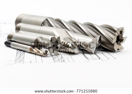 Professional cutting tools used for metalwork. Multi-flute drill, broach bit, Stainless Drill bit, Ripping Cutter. Royalty-Free Stock Photo #771255880