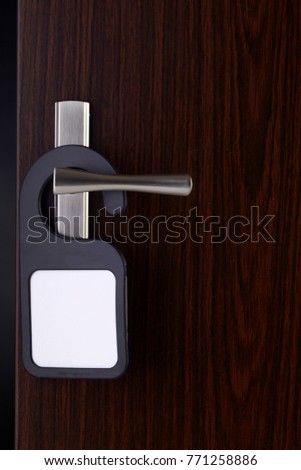 blank door sign hanging at door handle