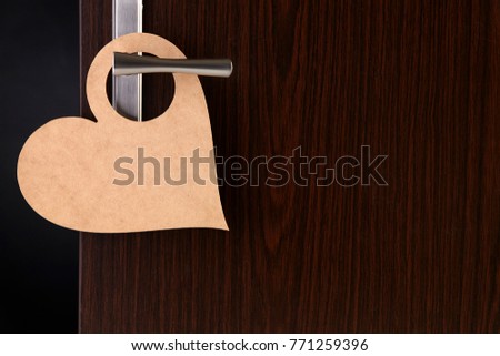 blank heart shape door sign hanging at door handle