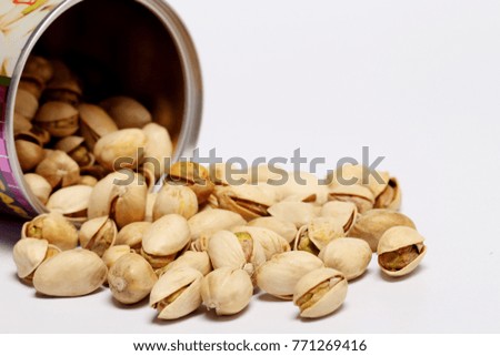 Pistachio nuts spilled out of container