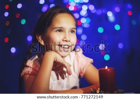 Night shot of the baby girl with candles with beautiful bokeh at background