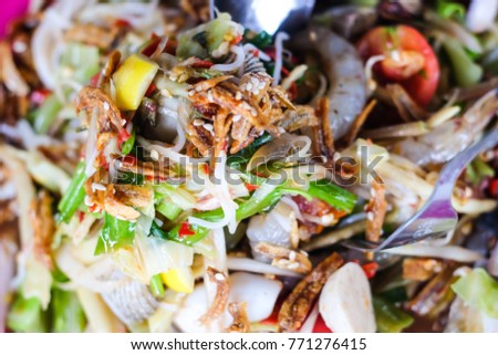 Papaya seafood salad traditional spicy Thai food called Somtum