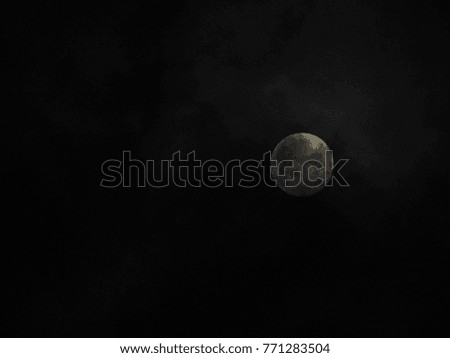 Blurred light in dark, soft moon effect over clouds