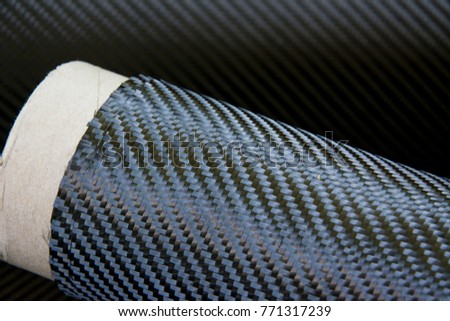 Black carbon fiber composite raw material in the roll background
