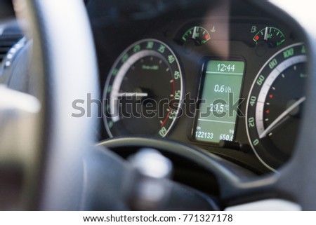 Close up dashboard of a modern car mileage and temperature Royalty-Free Stock Photo #771327178