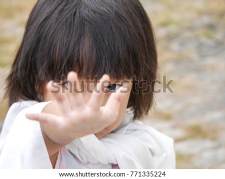 A little 3 years old girl is showing her hand.