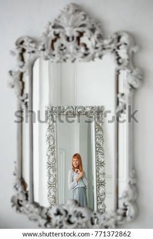 Young beautiful girl in christmas decoration at home