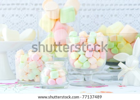 Still life with many marshmallow candies into a glass