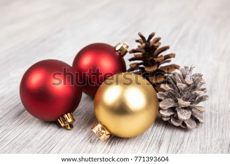 red and gold christmas balls on a wooden background