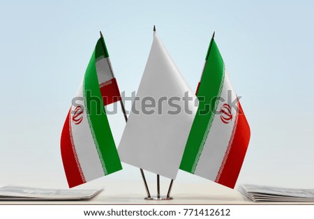 Two flags of Iran with a white flag in the middle