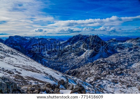 winter panorama of mount "grosser Priel" in the austrian alps with a unique rock and snow covered landscape, a great mountain panorama and spectacular blue sky with clouds