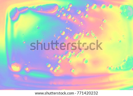 Beautiful macro close-up photography of holographic liquid with chemical reaction making bubbles and stains.  