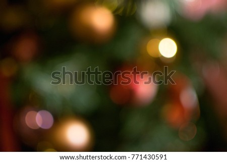 Decorated balls with a blurred Christmas tree