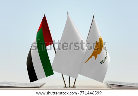 Flags of UAE and Cyprus with a white flag in the middle