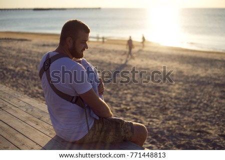 Father sits with son in the beach