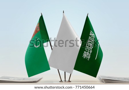 Flags of Turkmenistan and Saudi Arabia with a white flag in the middle