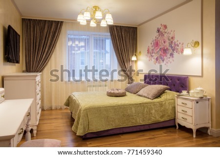 luxurious bedroom in purple and gold colors with window
