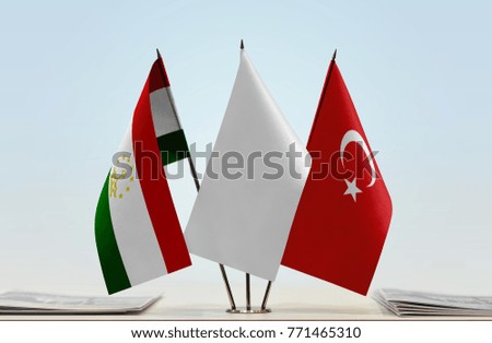 Flags of Tajikistan and Turkey with a white flag in the middle