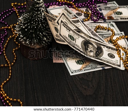 New Year Christmas tree is torn with snow and everywhere money, cash, dollars