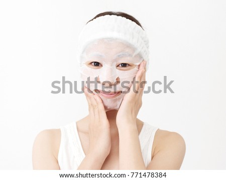 Asian woman applying a face pack  