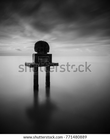 Fine art image in black & white of submerged signboard at Pulau Pinang Island, Malaysia. Soft Focus due to long exposure.