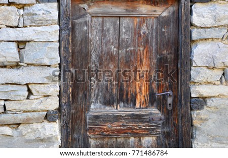 old wooden doors in the old stone building