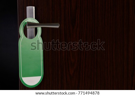 do not disturb door sign hanging at door handle