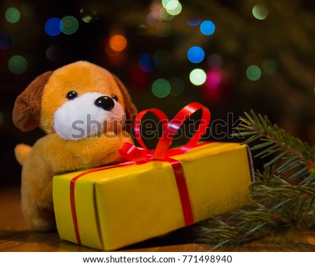 2018 -year of the yellow dog. The new toy under the fur-tree gives a gift.