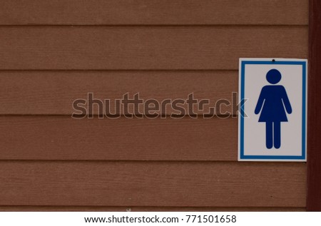Restroom Sign on wooden wall,Lady toilet sign.