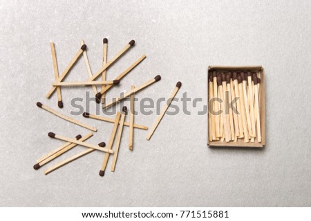 The concept of chaos and order. Chaotic match boxes lying around with the order of stacked matches Royalty-Free Stock Photo #771515881